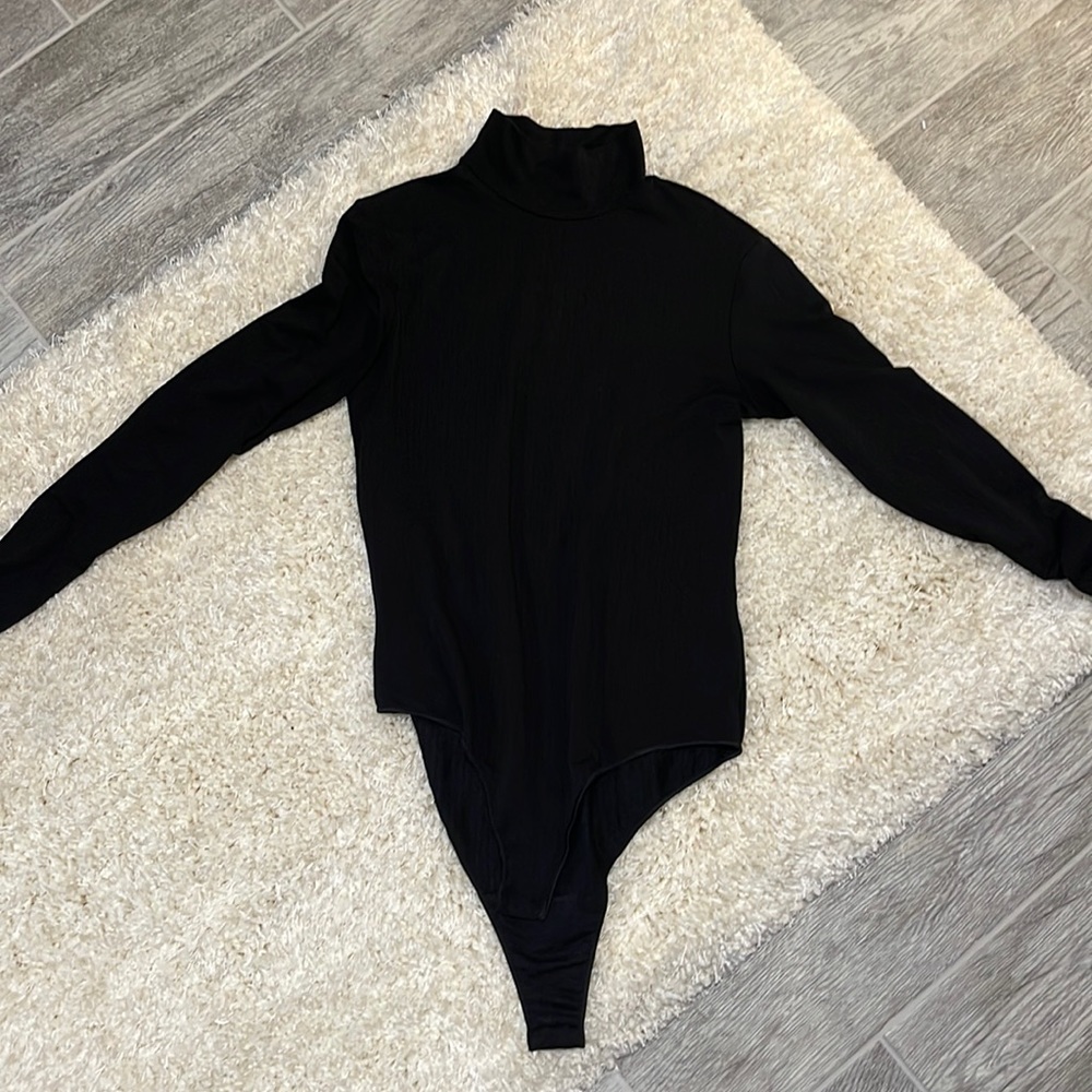 The top is Uniqlo it’s a black bodysuit very thin mid neck
